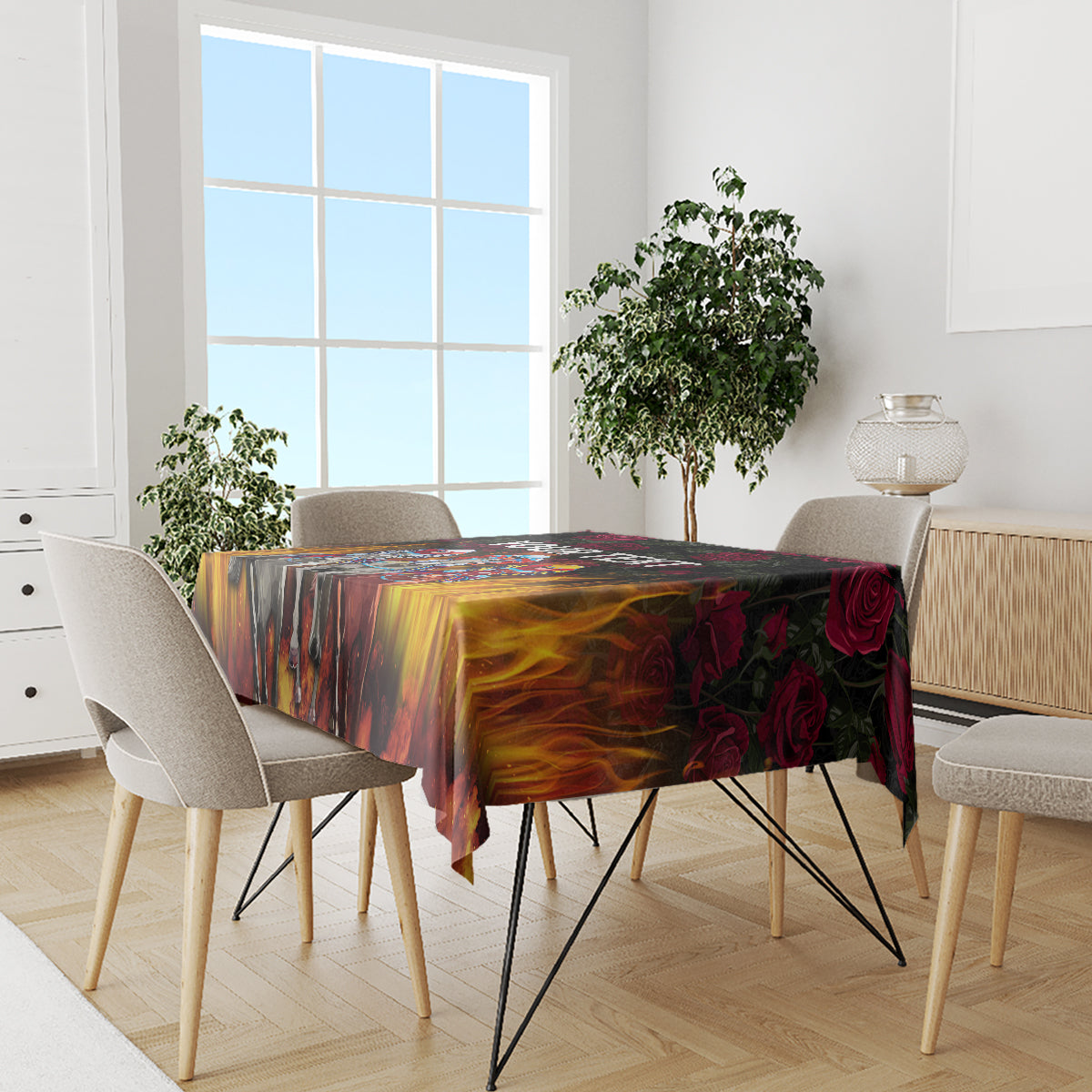Black tablecloth with colorful flame and rose print on dining table with chairs