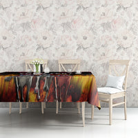 Black tablecloth with flame-and-rose artwork on a long dining table and chairs