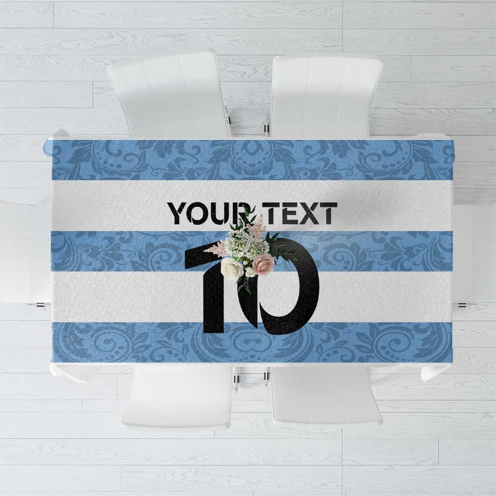 Custom tablecloth with blue ornamental band, black number graphic, and floral motif.