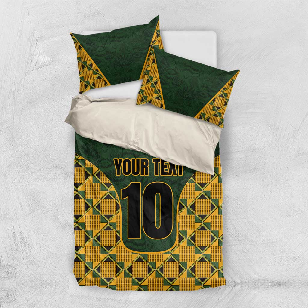 Green bedding set with kente pattern, two pillows, 'YOUR TEXT' and number 10.