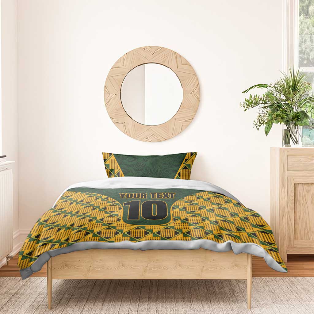 Green and gold kente-pattern bedding set with 'YOUR TEXT' and number 10 on duvet.