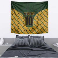 Green and yellow geometric kente tapestry with gold '10' and 'YOUR TEXT'.