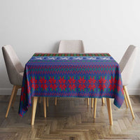 Blue Christmas tablecloth with red-green tartan pattern and striped border on table