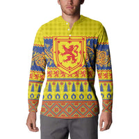 Yellow button henley sweatshirt on model, red shield graphic with blue trim patterns