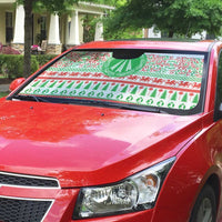 Auto sun shade on red car windshield, green and red festive Celtic design