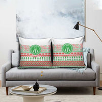 Christmas pillow covers on sofa with green Awen emblem and red/green patterns
