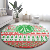 Round Christmas rug featuring green tree in a circular medallion and red/green festive patterns