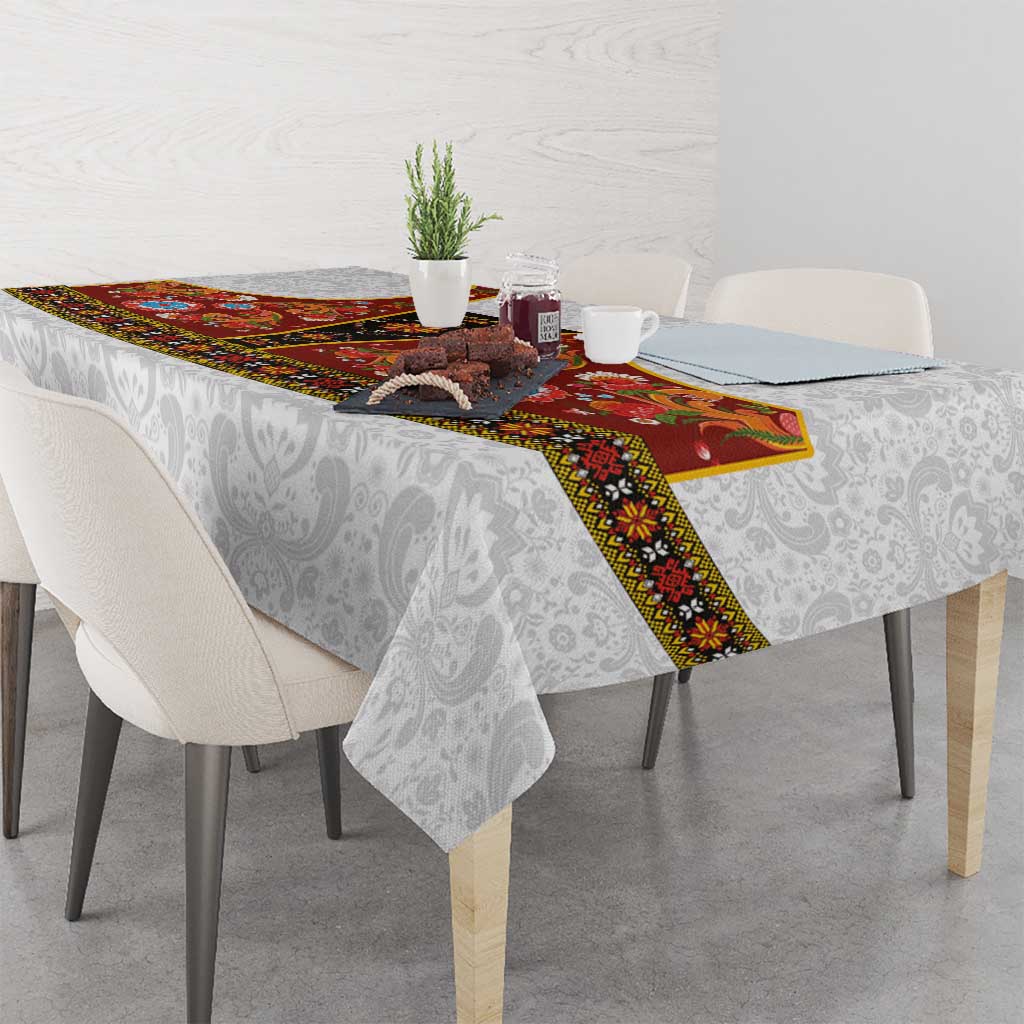 Gray damask tablecloth with red rosemaling panel and floral border across table
