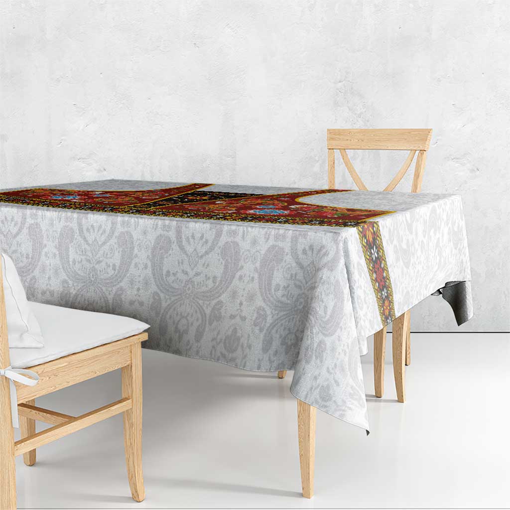 Gray damask tablecloth with red rosemaling border and corner-overhang drape