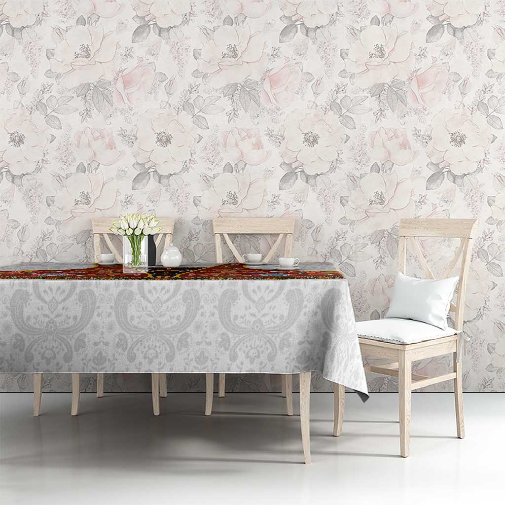 Gray damask tablecloth with red rosemaling runner and colorful floral accents
