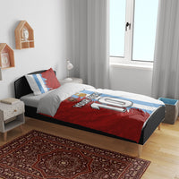 Football bedding set on bed: red and white duvet with light-blue stripe panel and pillow set