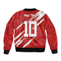 Red bomber jacket back with white diagonal stripes and large number 10 graphic, ribbed hem.