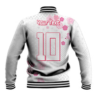 White baseball jacket back with large pink number 10, cherry blossoms, striped rib trim.