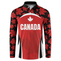 Red button rugby sweatshirt with black maple leaf pattern and Canada crest on chest