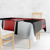 Red and black maple leaf tablecloth draped over table with white side panels