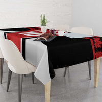 Black and red maple leaf tablecloth with white draped corners on dining table