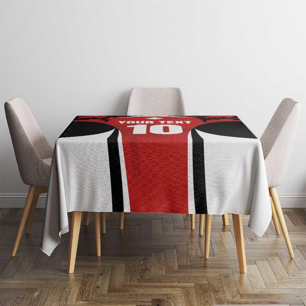 Rectangular red, black and white maple leaf tablecloth centered on dining table