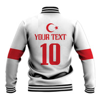 White baseball jacket back with red crescent-star, large number 10, ribbed hem.