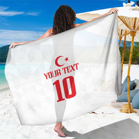 White sarong with red crescent emblem and 'YOUR TEXT 10' print, draped over shoulders