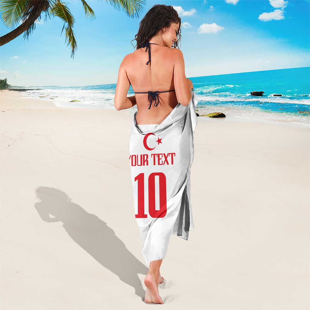 White sarong tied at waist with red 'YOUR TEXT 10' emblem print