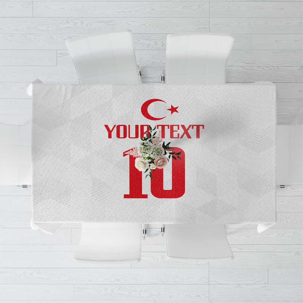 White tablecloth with red crescent-star and floral “10” graphic