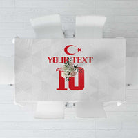 White tablecloth with red crescent-star and floral “10” graphic