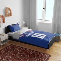 Blue bedding set with duvet and two pillows on bed, France stripe design and number 10