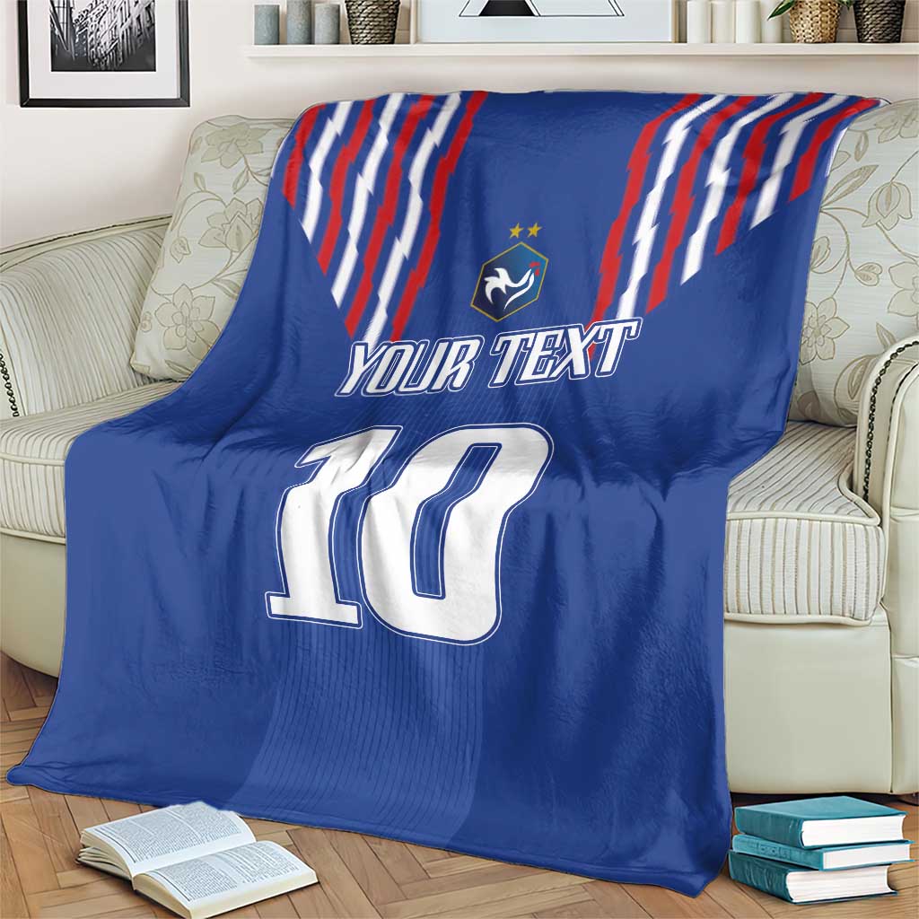 Blue blanket with red-white stripe design, crest, “YOUR TEXT” and number 10 on sofa