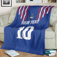 Blue blanket with red-white stripe design, crest, “YOUR TEXT” and number 10 on sofa