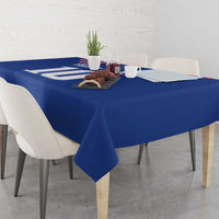 Blue soccer-themed tablecloth draped over rectangular dining table with chairs