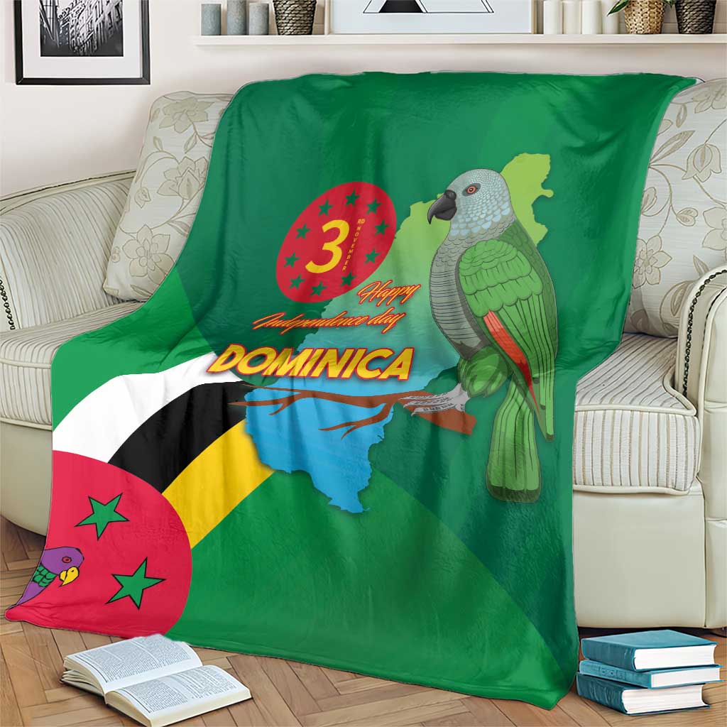 Green blanket showing Dominica flag diagonal stripes, map, and parrot bird graphic