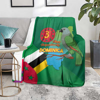 Green Dominica throw blanket with flag, map, parrot, and corner draped over rug