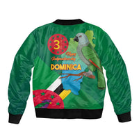 Green bomber jacket back, black ribbed hem; parrot with “Happy Independence Day” and “DOMINICA”