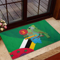 Green rubber doormat with Dominica flag design and parrot near doorway