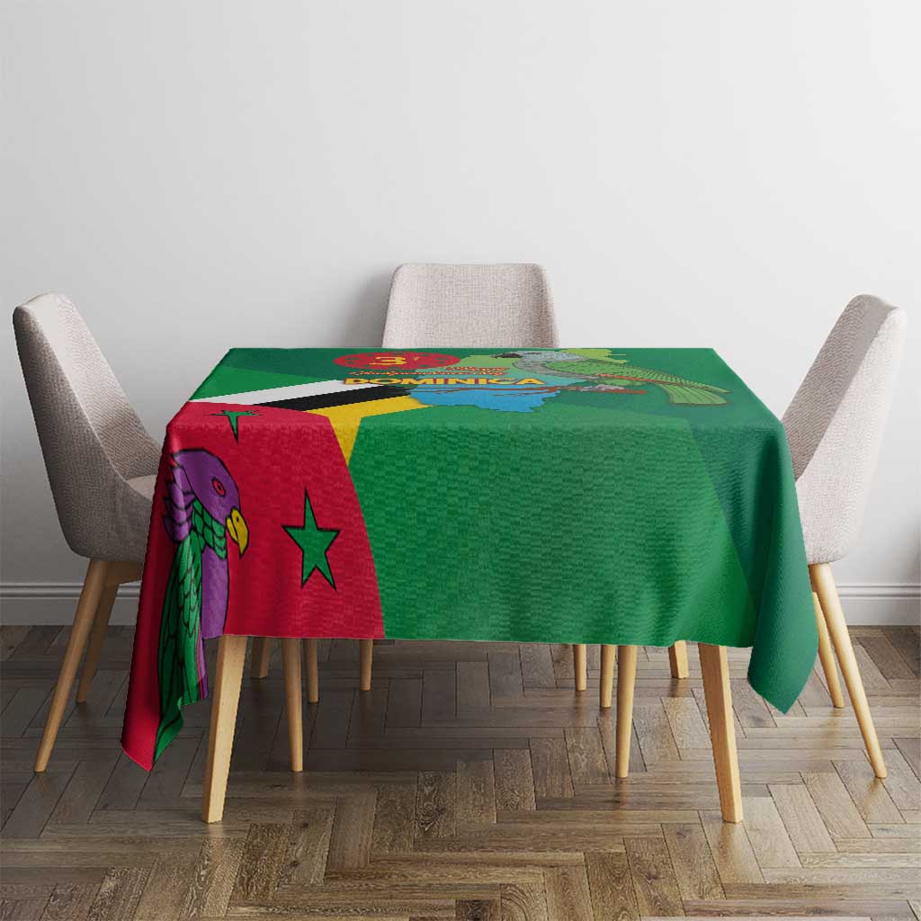 Green tablecloth featuring Dominica flag, map, and bird emblem on table