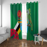 Green window curtain with Dominica flag print and parrot bird design, hung with hooks