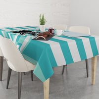 Teal and white geometric tablecloth on dining table with striped chevron pattern