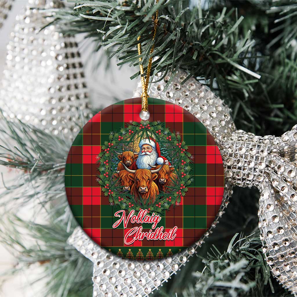 Round Scottish tartan ceramic ornament with Santa and Highland cows, hanging on a tree