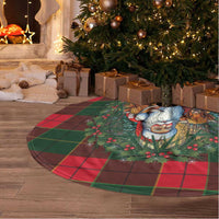 Circular red and green tartan tree skirt with Santa and cows graphic, fringed edge
