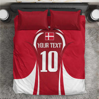 Red football bedding set on gray rug with central jersey-style '10' graphic and pillows