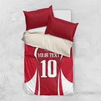 Red football bedding set, flat lay with red/white jersey graphic and two striped pillowcases