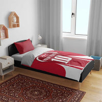 Red football bedding set with jersey-style '10' comforter and two striped pillowcases