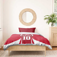 Red football bedding set with jersey-style '10' comforter and two striped pillowcases
