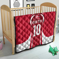 Red and white quilt blanket on crib with number 10 and custom text design