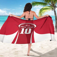 Red football sarong with back-facing wearer, white number 10 crest and text