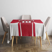 Red and white tablecloth with bold vertical stripes and jersey crest on round table