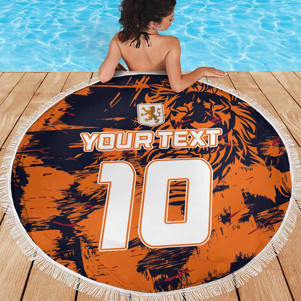 Orange round beach blanket with navy graphic, YOUR TEXT 10, crest, white tassel fringe