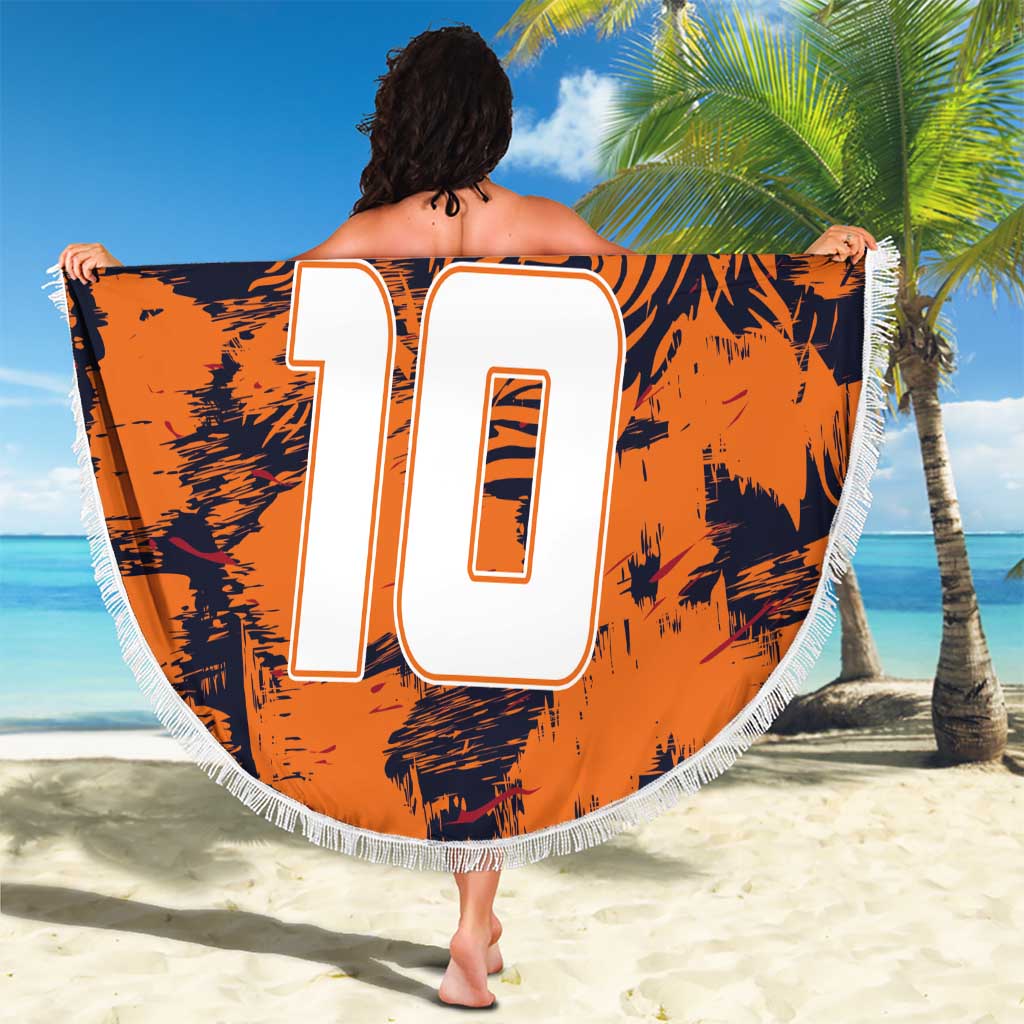 Orange round beach blanket with navy tiger print, large white 10, crest, white fringe