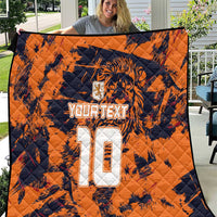 Orange quilt blanket with navy tiger print and large white number 10 design