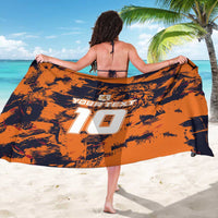 Orange football sarong with black splash pattern, back print showing white number 10